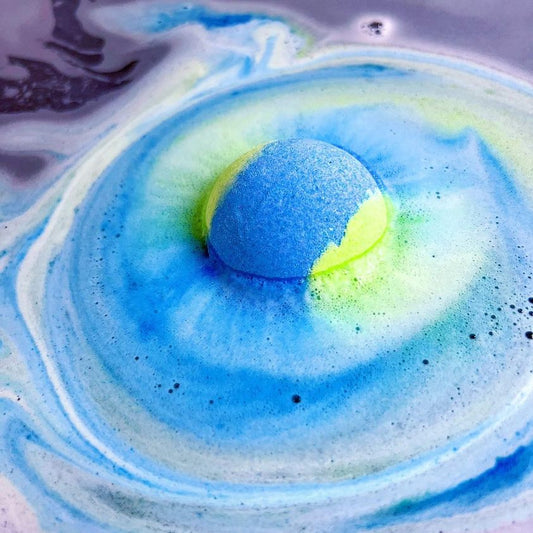 Planet earth bath bomb fizzing and swirling in water