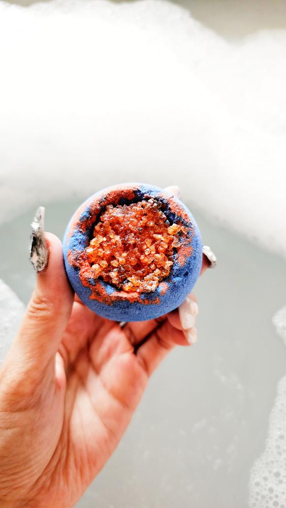 Nebula grapefruit bath bomb handheld close up shot